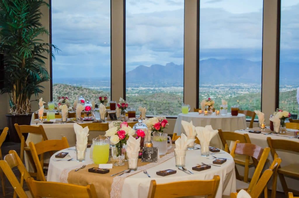 A picture of tables set in a dining room with a view