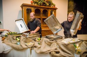 A picture of tucson creative catering staff in action about to serve food